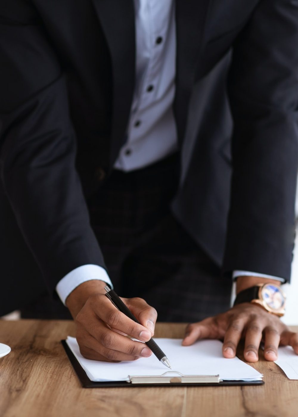 Cropped of african manager signing papers in office